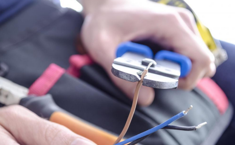 Electrician working with electrical tools